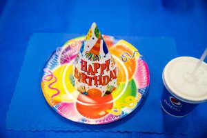 Birthday hat and plate on table