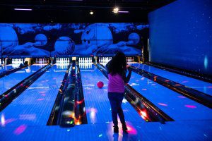 Girl cosmic bowling